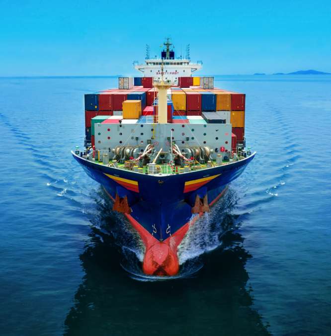 Aerial in front view of cargo ship carrying container and running for export  goods  from  cargo yard port to custom ocean concept technology transportation , customs clearance.